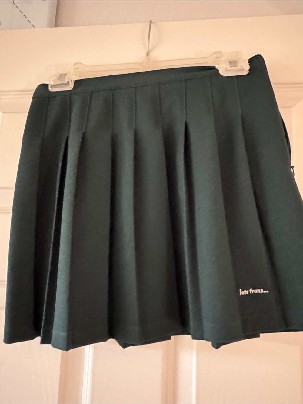 Pleated Mini Skirt in Dark Green with Subtle Logo